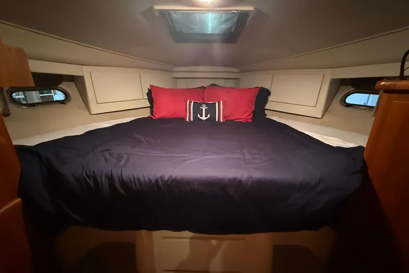 Slide: The Image of Cozy cabin bedroom in 1994 Carver 370 Voyager yacht with nautical-themed pillows. - 27