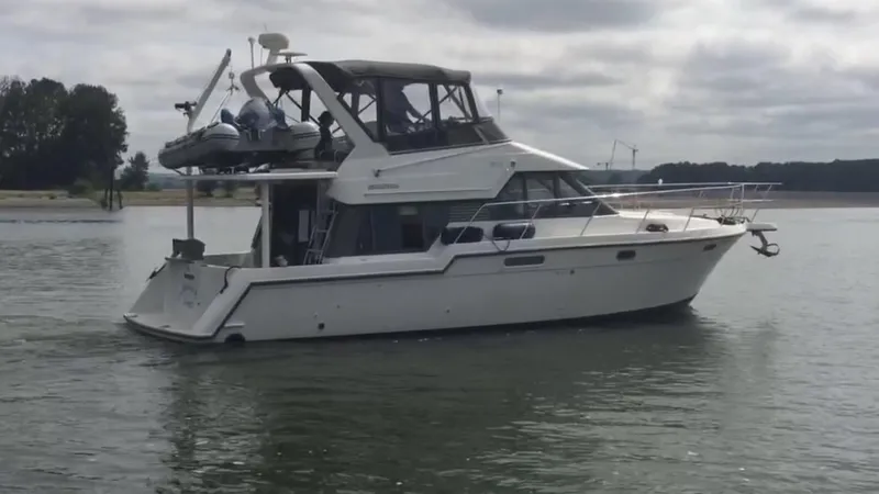 Slide: The Image of 1994 Carver 370 Voyager yacht on calm waters. - 38