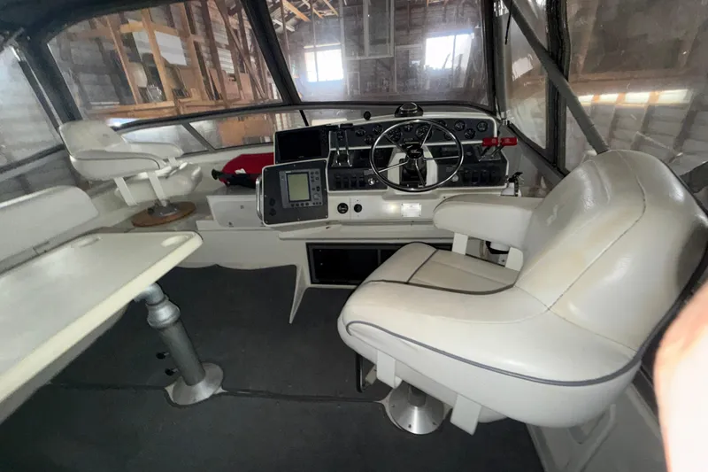 Slide: The Image of Interior of a 1994 Carver 370 Voyager boat with helm and seating area. - 4