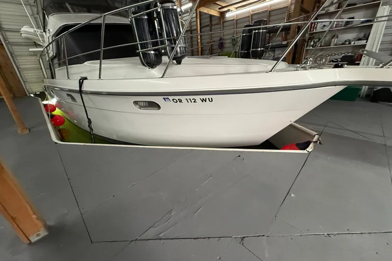 Slide: The Image of 1994 Carver 370 Voyager yacht docked in a spacious indoor marina. - 42