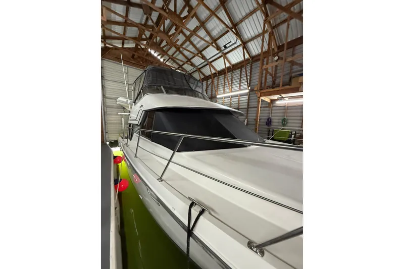 Slide: The Image of 1994 Carver 370 Voyager yacht docked in a covered marina. - 43