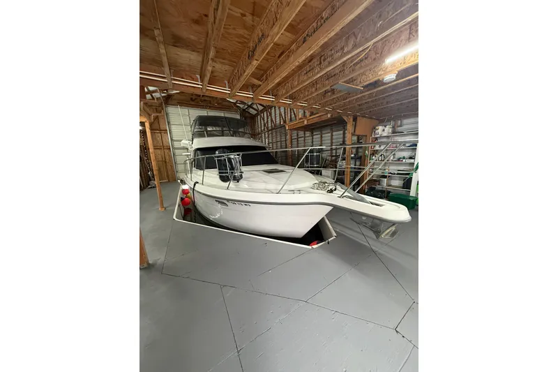 Slide: The Image of 1994 Carver 370 Voyager yacht stored in a wooden boathouse. - 46