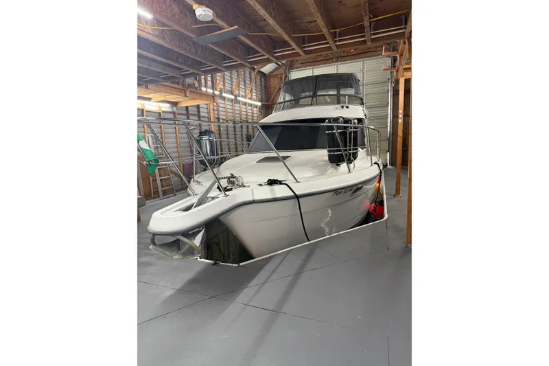 Slide: The Image of 1994 Carver 370 Voyager yacht stored indoors, showcasing sleek design and sturdy build. - 47