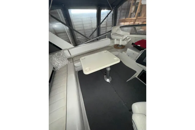 Slide: The Image of Interior of 1994 Carver 370 Voyager yacht with seating and table arrangement. - 5