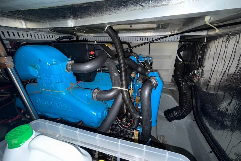 Slide: The Image of Engine compartment of a 1994 Carver 370 Voyager, featuring a blue Crusader engine. - 51