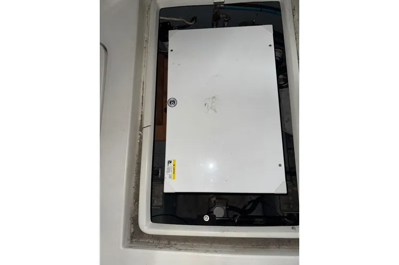 Slide: The Image of Engine compartment of a 1994 Carver 370 Voyager boat, featuring a white panel. - 52