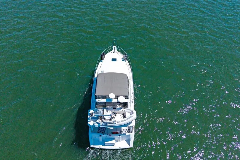 Slide: The Image of Aerial view of 1994 Carver 370 Voyager yacht cruising on open water. - 73
