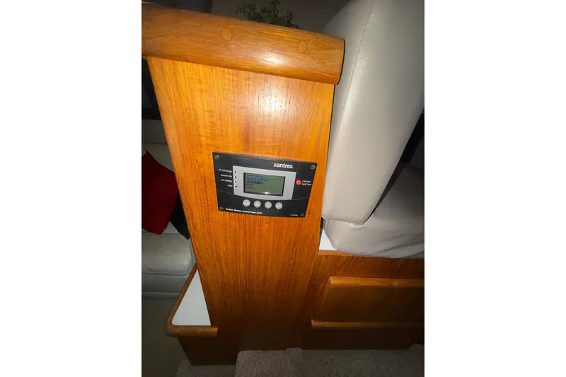 Slide: The Image of 1994 Carver 370 Voyager interior with Xantrex control panel on wooden paneling. - 9