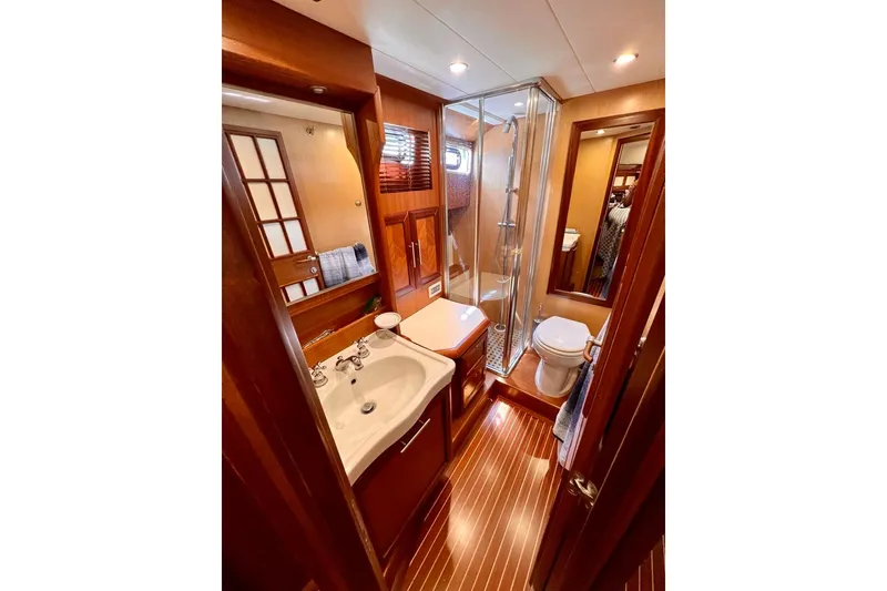 Slide: The Image of Luxurious bathroom in 2006 Mochi Craft 51 Dolphin yacht with wood accents and modern fixtures. - 14