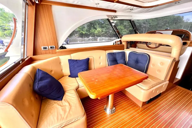 Slide: The Image of Luxurious interior of 2006 Mochi Craft 51 Dolphin yacht with leather seating and wooden table. - 15