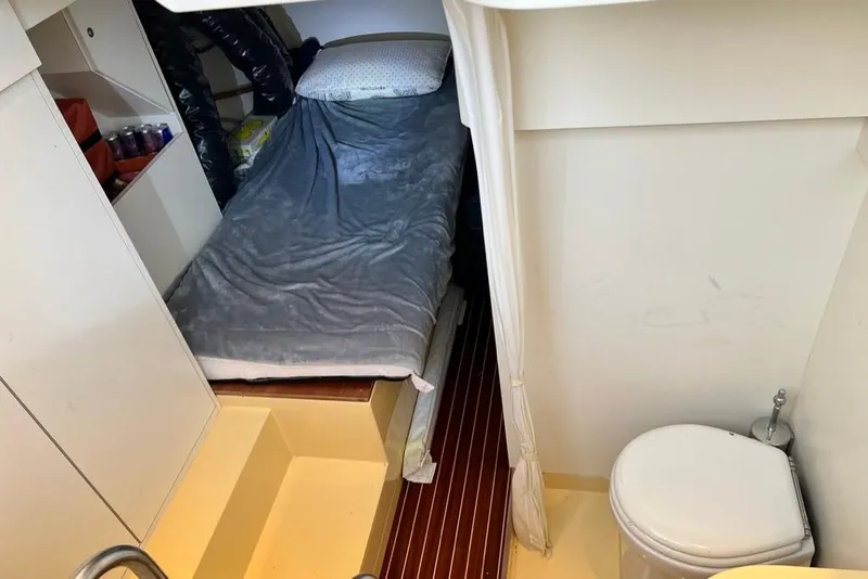 Slide: The Image of Cabin interior of 2006 Mochi Craft 51 Dolphin with bed and compact bathroom. - 16