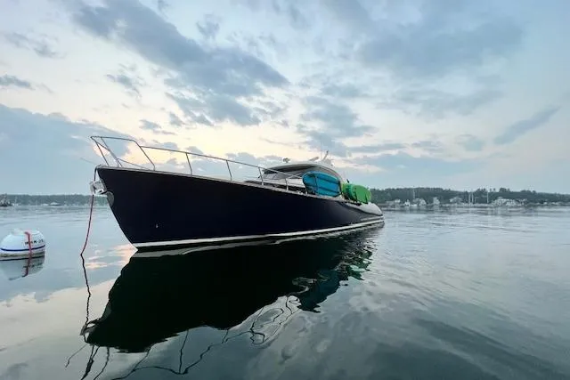 Slide: The Image of 2006 Mochi Craft 51 Dolphin yacht on calm water at sunset. - 5