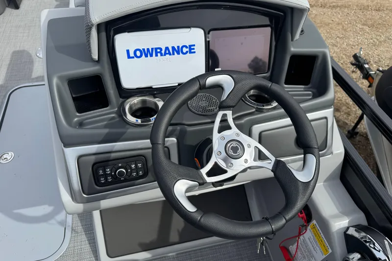 Slide: The Image of Steering console of 2025 Regency 230 DL3 boat with Lowrance display and controls. - 10