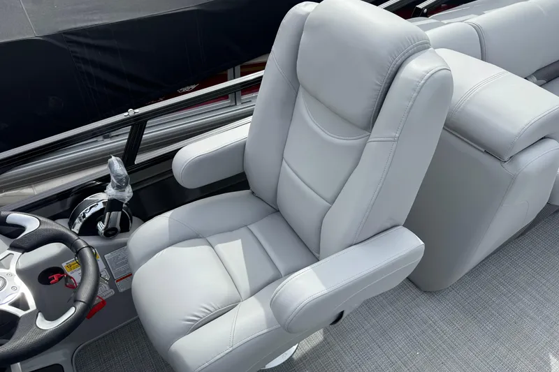 Slide: The Image of Luxurious seating in the 2025 Regency 230 DL3 boat, featuring plush gray upholstery. - 11