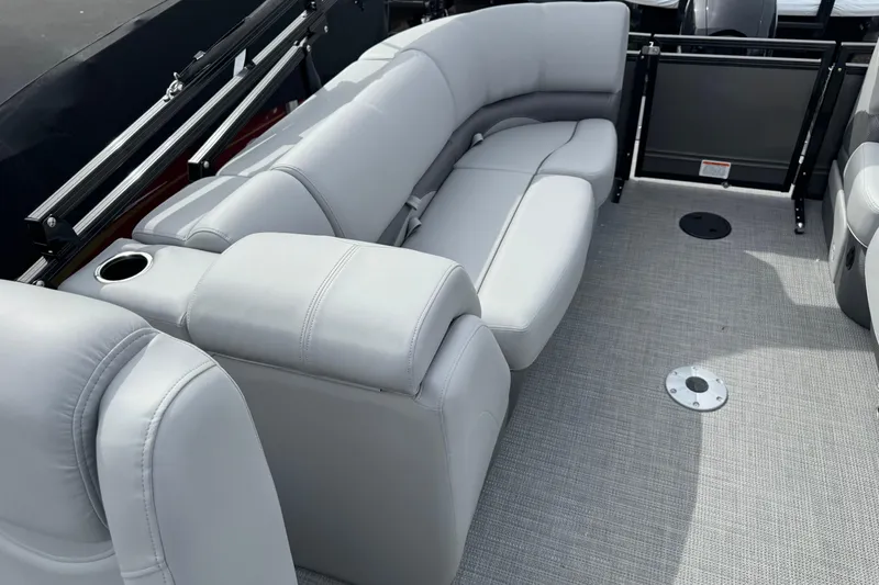 Slide: The Image of Luxurious seating on 2025 Regency 230 DL3 pontoon boat, featuring plush gray upholstery. - 12