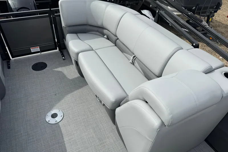 Slide: The Image of Luxurious seating on 2025 Regency 230 DL3 pontoon boat, featuring plush gray upholstery. - 13