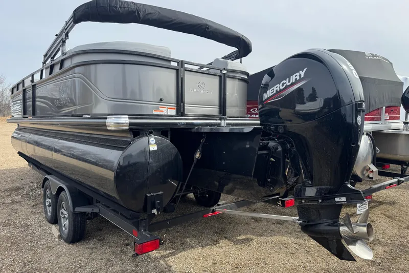 Slide: The Image of 2025 Regency 230 DL3 pontoon boat with Mercury outboard motor on trailer. - 3