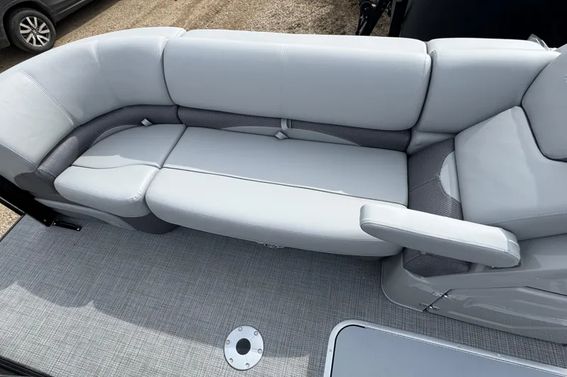 Slide: The Image of Luxurious seating on 2025 Regency 230 DL3 pontoon boat, featuring sleek gray upholstery. - 6