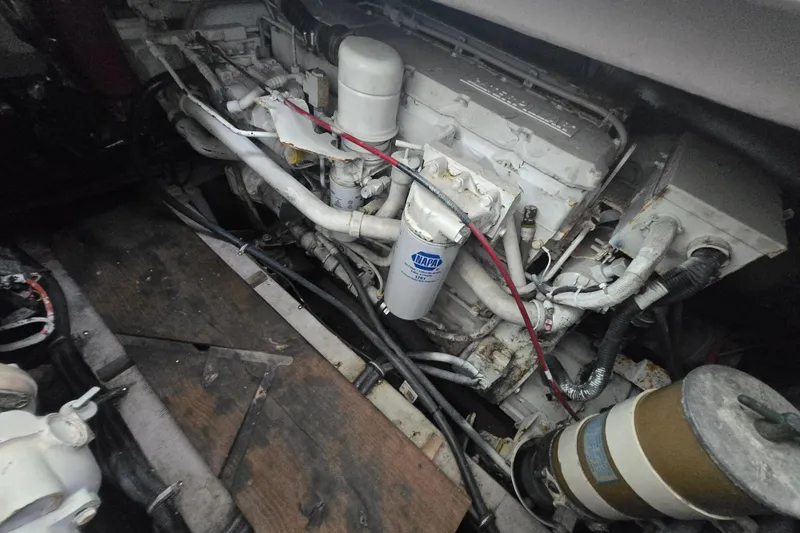 Slide: The Image of Engine compartment of a 1998 Wellcraft 330 Coastal boat, showcasing mechanical components. - 16