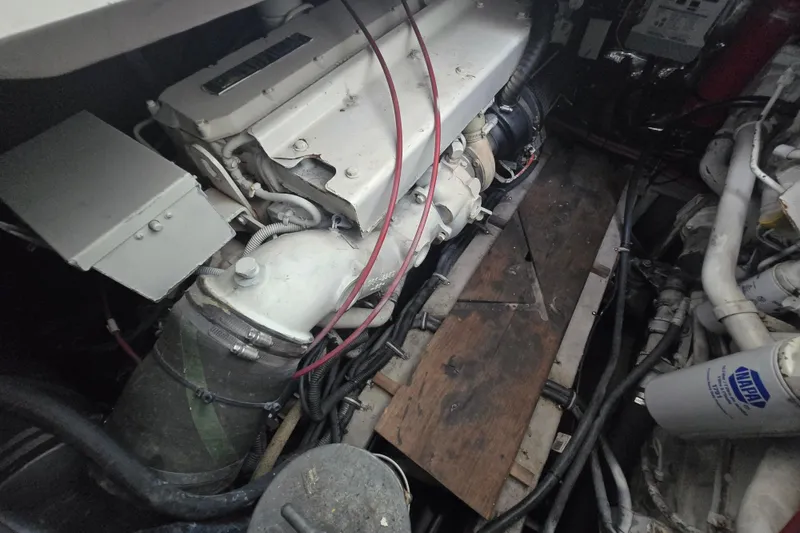 Slide: The Image of Engine compartment of a 1998 Wellcraft 330 Coastal boat, showcasing mechanical components. - 17