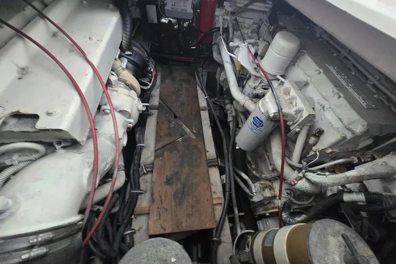Slide: The Image of Engine compartment of a 1998 Wellcraft 330 Coastal boat, showing mechanical components and wiring. - 19