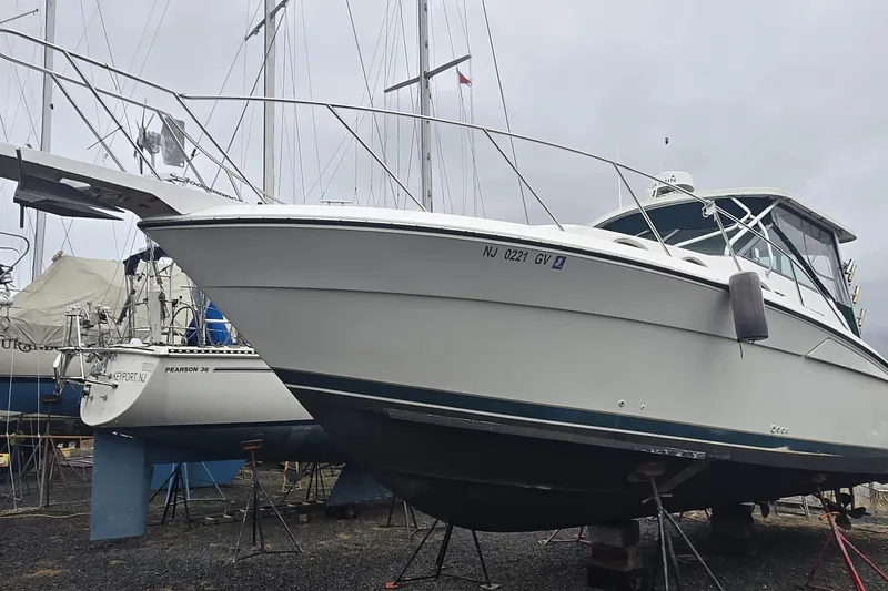 Slide: The Image of 1998 Wellcraft 330 Coastal boat on dry dock, surrounded by other vessels. - 22