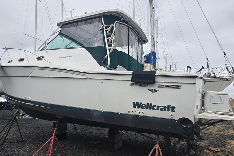 Slide: The Image of 1998 Wellcraft 330 Coastal boat on stands, ready for maintenance. - 23