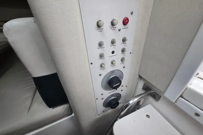Slide: The Image of Control panel of a 1998 Wellcraft 330 Coastal boat, featuring various switches and dials. - 25