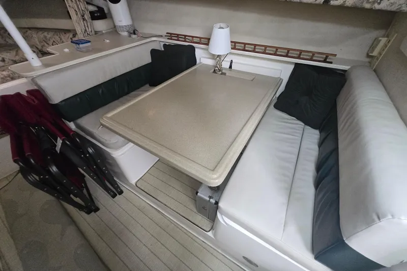 Slide: The Image of Interior of a 1998 Wellcraft 330 Coastal boat with a cozy dining area. - 4