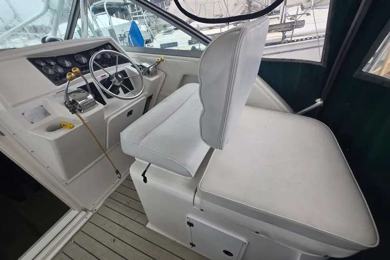 Slide: The Image of 1998 Wellcraft 330 Coastal helm with white seating and control panel. - 7