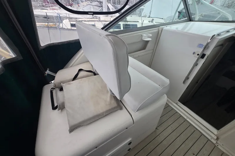 Slide: The Image of Interior of a 1998 Wellcraft 330 Coastal boat with white seating and wooden flooring. - 8