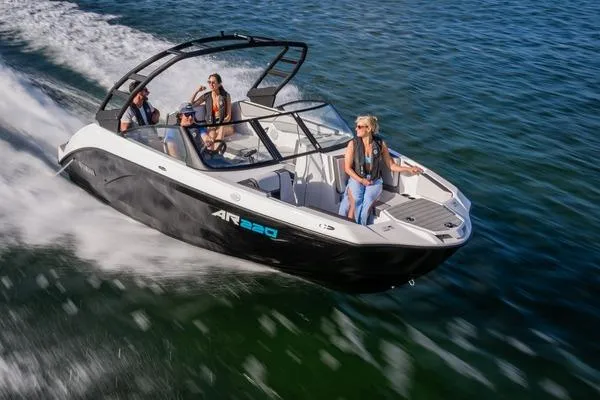 The Image of 2025 Yamaha Boats AR220 on trailer at marina, ready for launch. - 1