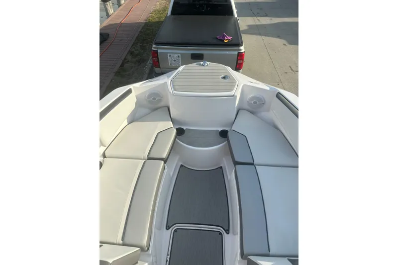 Slide: The Image of 2025 Yamaha Boats AR220 interior with cushioned seating and modern design. - 23