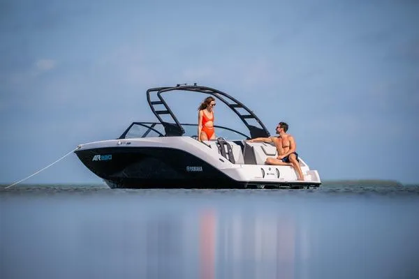 Slide: The Image of 2025 Yamaha Boats AR220 swim platform with cushioned seating and cup holders. - 6