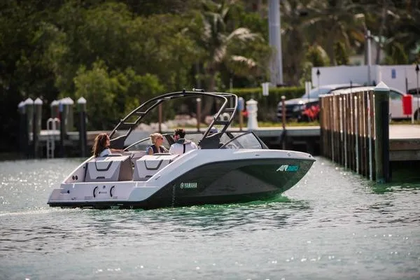 Slide: The Image of 2025 Yamaha Boats AR220 interior with dockside view and marina background. - 9
