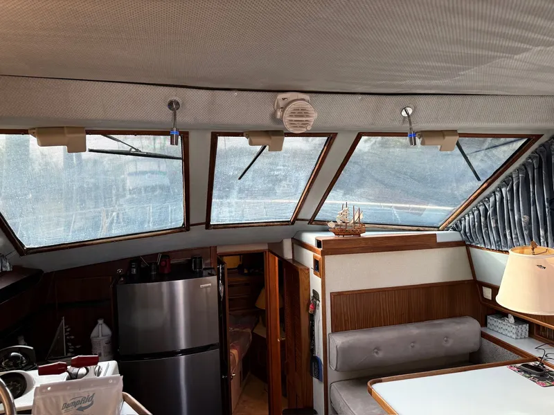 Slide: The Image of Interior of a 1988 Sea Ray 415 Aft Cabin yacht with kitchen and dining area. - 12