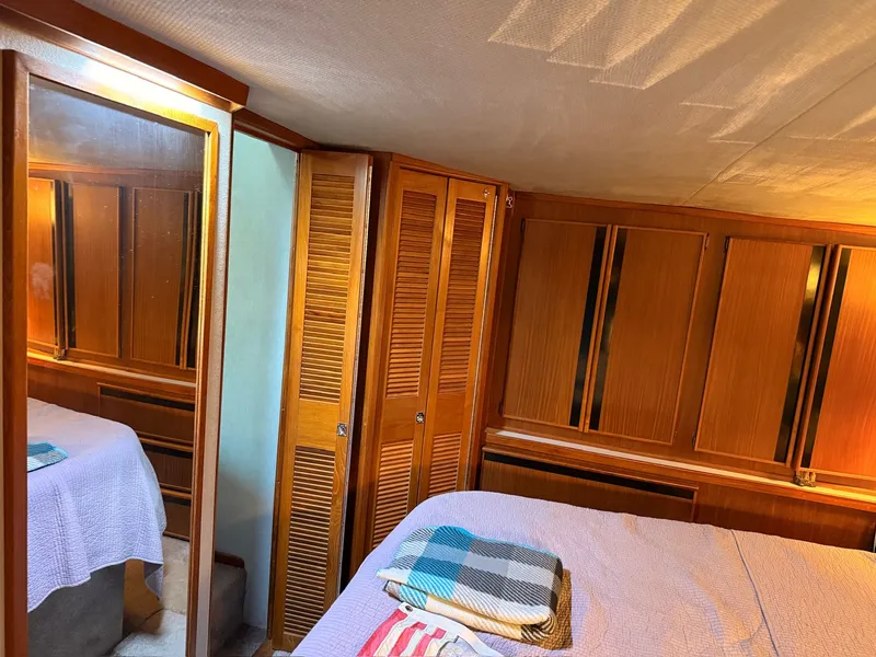 Slide: The Image of Interior of 1988 Sea Ray 415 Aft Cabin with wooden furnishings. - 27