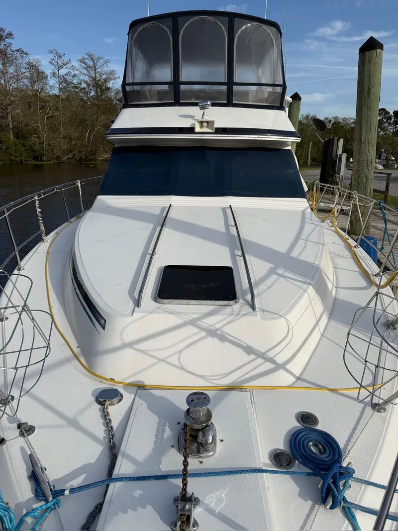 Slide: The Image of 1988 Sea Ray 415 Aft Cabin yacht at dock, front deck view. - 32