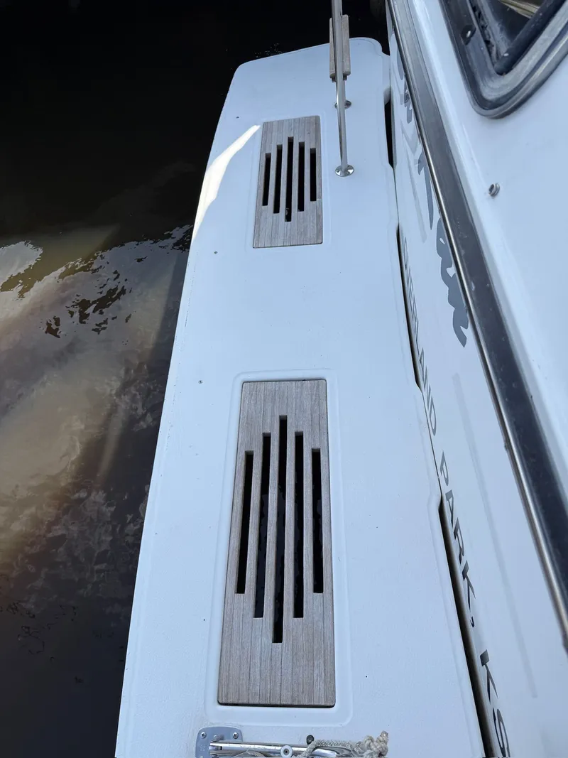 Slide: The Image of 1988 Sea Ray 415 Aft Cabin boat deck with wooden details. - 33