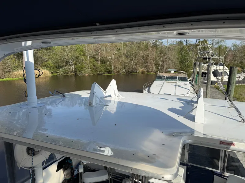 Slide: The Image of 1988 Sea Ray 415 Aft Cabin docked on a tranquil river. - 34