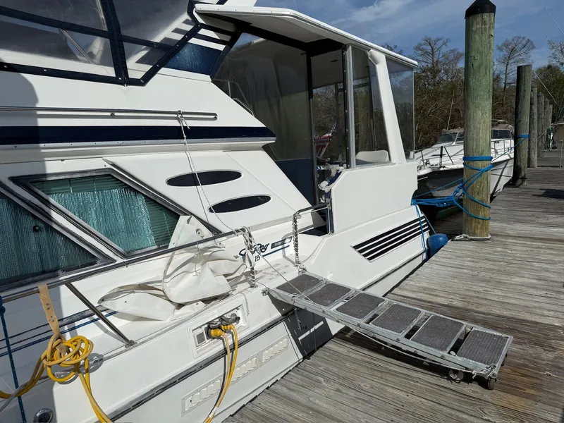 Slide: The Image of 1988 Sea Ray 415 Aft Cabin at dock with gangway. - 4