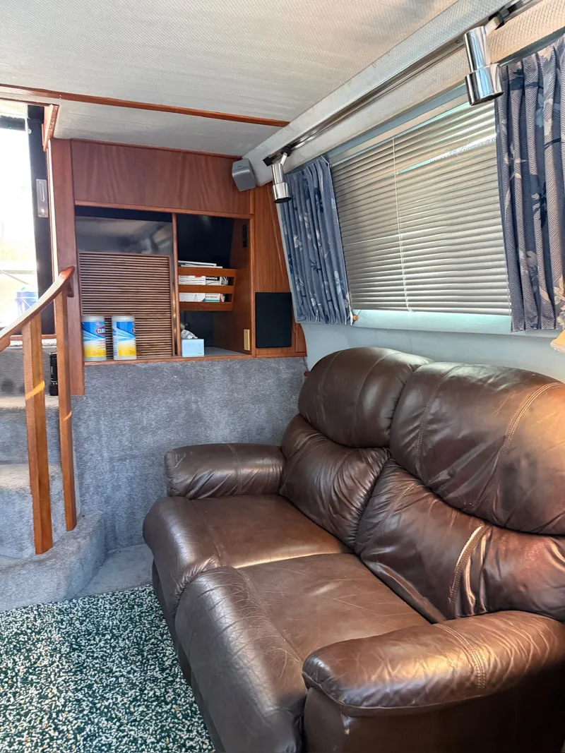 Slide: The Image of Interior of a 1988 Sea Ray 415 Aft Cabin with leather sofa. - 9