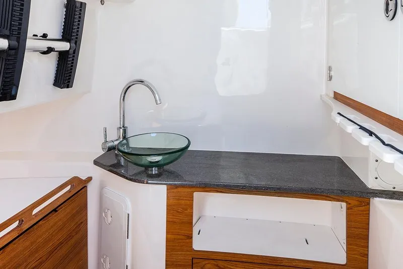 Slide: The Image of Interior of 2013 Everglades 355 Center Console with modern sink and countertop. - 11