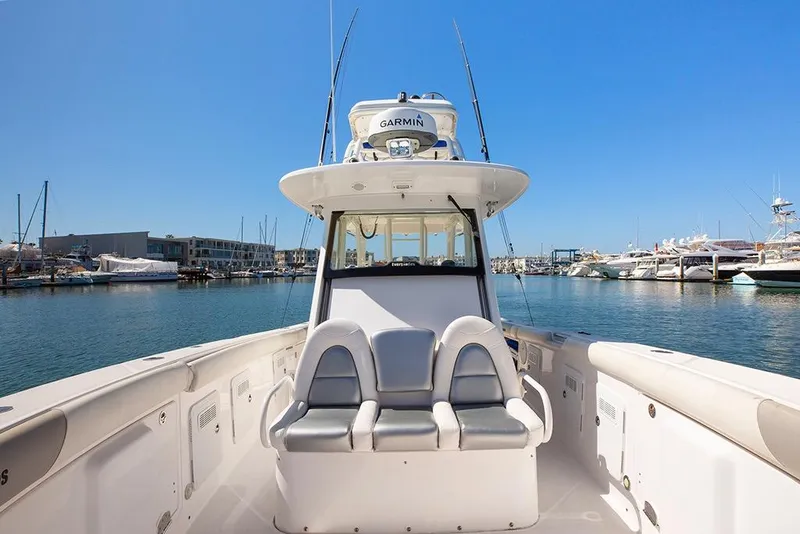 Slide: The Image of 2013 Everglades 355 Center Console boat docked in marina under clear blue sky. - 6