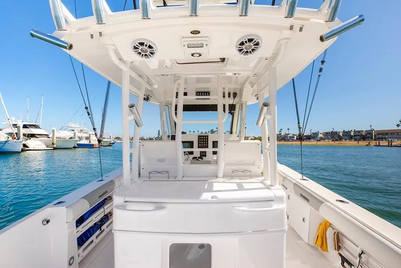 Slide: The Image of 2013 Everglades 355 Center Console boat interior with ocean view and marina backdrop. - 7