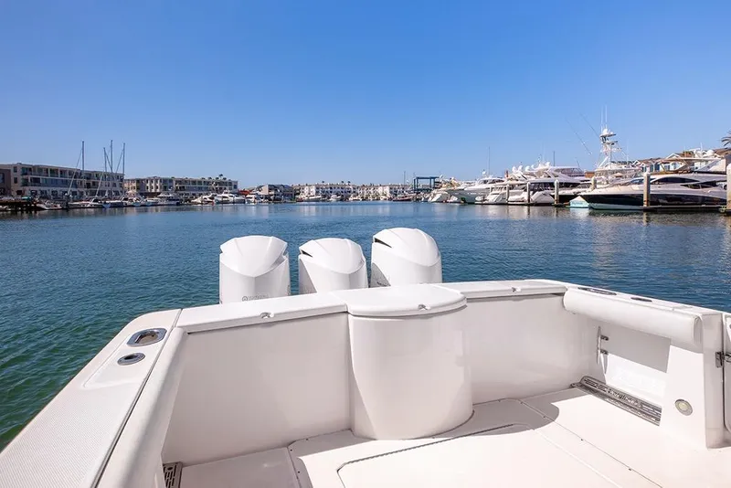 Slide: The Image of 2013 Everglades 355 Center Console boat docked in a marina under clear blue skies. - 8