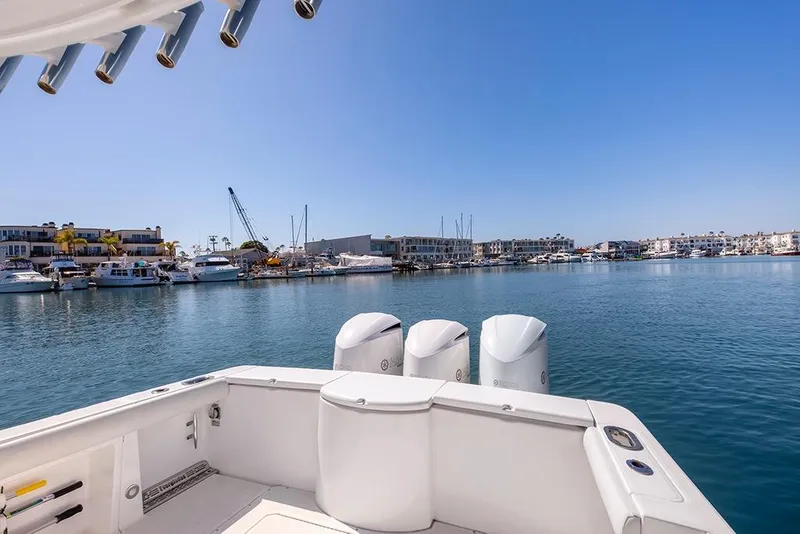 Slide: The Image of 2013 Everglades 355 Center Console boat docked in a marina with clear blue skies. - 9