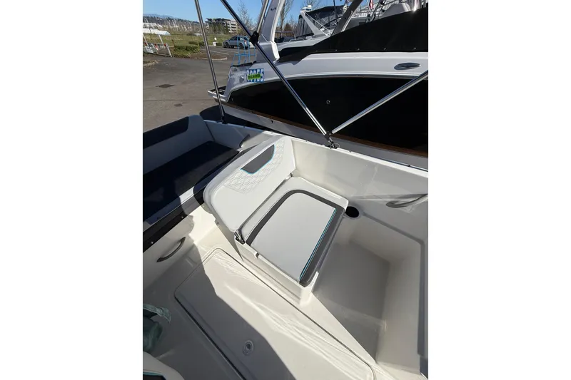 Slide: The Image of 2024 Bayliner Element M19 boat interior with seating and storage area. - 10
