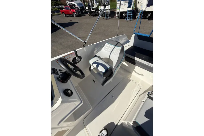 Slide: The Image of 2024 Bayliner Element M19 boat interior with steering wheel and seating. - 11