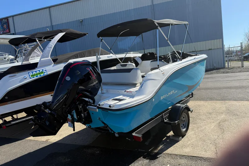 Slide: The Image of 2024 Bayliner Element M19 boat with outboard motor, parked outdoors. - 3
